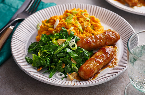 Teriyaki-glazed sausages are given a mountain of sweet potato mash for company in this hearty twist on a British classic