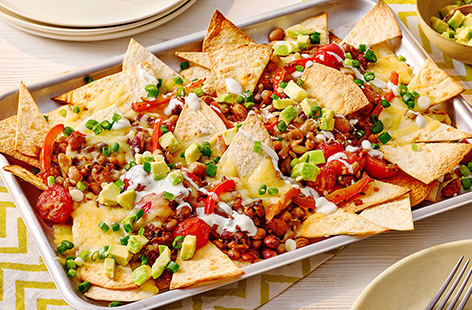 Make your own nachos using tortilla wraps and top with melted cheese, spicy beans and a homemade salsa. Finish off with some cooling guacamole and tuck in.