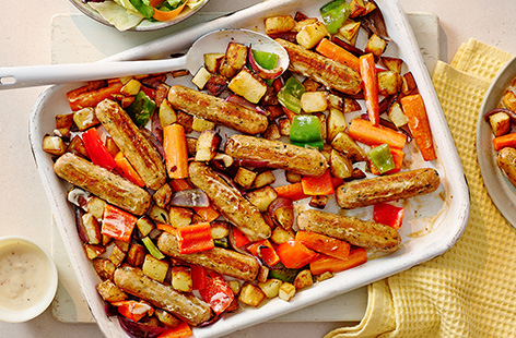 Let the oven do all the work in this vegetarian sausage traybake recipe. Coat you veggie sausages in a honey mustard glaze, then cook with potatoes, peppers and onions.
