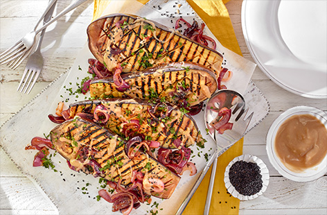 Create an impressive vegetarian barbecue main course or side dish with whole blackened aubergines. Drizzled in a garlicky tahini sauce and topped with Tesco Fire Pit caramelised red onions, it's a great way to jazz up a classic summer vegetable.