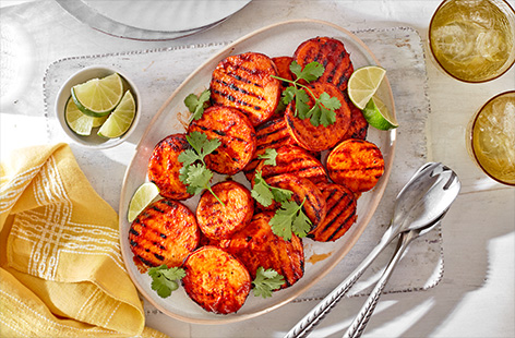 Smother slices of sweet potato in Tesco Fire Pit The Smoky One marinade in this easy barbecue side recipe. Served with plenty of fresh lime and coriander, it's the perfect accompaniment to any barbecue spread.
