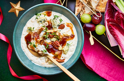 Add new flavours and textures to a readymade cheese and chive dip with tangy Stilton, sweet chutney, fresh herbs and chopped nuts. It's ready in minutes, but looks homemade, and most importantly, it tastes amazing! Serve with grapes and crackers.