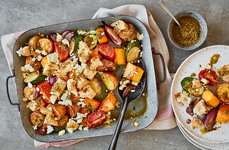 Transform a fridge full of veg into this pesto vegetable traybake recipe for a colourful, vegetarian dinner. Toss potatoes, courgettes, tomatoes and red onions in pesto for a herby boost of flavour, then bake with crispy croutons.