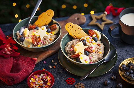 A wonderful Christmas breakfast idea; porridge made with cinnamon and nutmeg then topped with a mini gingerbread man, banana, blueberries and chocolate stars.