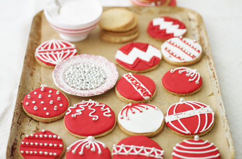 Test your piping skills with these colourful biscuit baubles which you can decorate any way you like