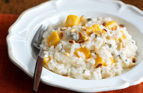 Risotto is a great way of making delicious ingredients go further and this recipe is no exception. Peeled and cubed butternut squash is softened with garlic and then gently cooked with rice in wine and stock. For extra oompf, Gorgonzola and toasted pinenuts are added at the end.
