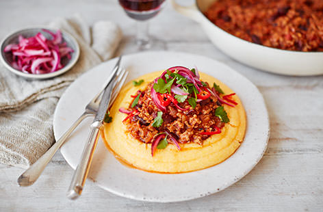 Creamy, buttery polenta is topped with a helping of fiery chipotle-spiced chilli beef in this Mexican-inspired supper, perfect for rustling up midweek.