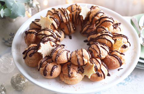 Light, airy and dangerously addictive, choux buns are one of our favourite desserts. This recipe – which involves assembling cream-filled choux buns in a festive wreath – is the perfect embodiment of Christmas cheer. Besides, it's hard not to love a chocolate drizzle.