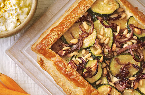 This is a brilliant tart to make when friends or family are coming over for lunch. Tender courgettes and sweet red onions are a great filling – especially when nestled on top of the creamy, cheesy filling. Pine nuts add a gorgeous crunch.