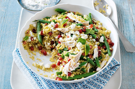 A colourful couscous salad with moist chicken, creamy feta, sweet pomegranate jewels and fresh mint yogurt