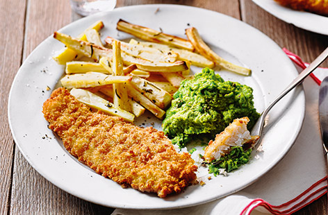 Try a healthy twist on classic fish and chips with this winning family dinner idea, ready in just over half an hour. The whole family are sure to love the parsnip chips and simple mushy peas