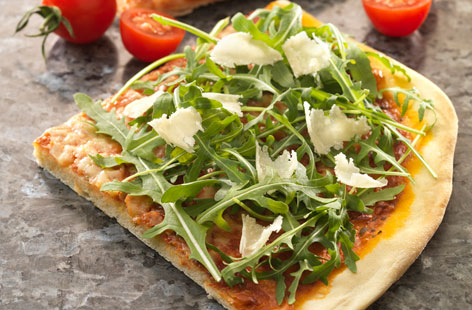 Making your own pizza couldn't be easier with this pesto pizza recipe. Using packet pizza or bread dough mix, top with pesto and passata, then add garlic, herbs, rocket and cheeses. Healthy, easy and tasty.