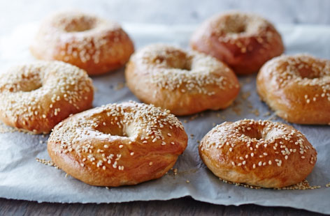 These DIY bagels are a nifty way to spend an afternoon. Unexpectedly, bagels are boiled before baking, but their telltale chewy texture is well worth the extra step. Whilst in the oven, prepare a spread of your favourite ingredients so the bagels can be eaten warm.