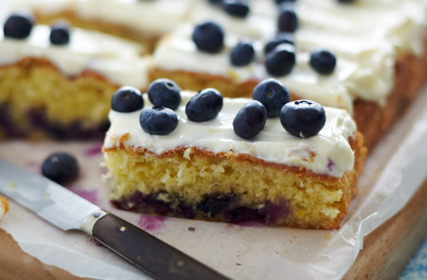 Bake this easy fruity traybake for picnics or packing into lunchboxes as a treat. Fluffy vanilla sponge is studded with juicy blueberries and topped with a smooth cream cheese icing for the perfect cake to feed a crowd.