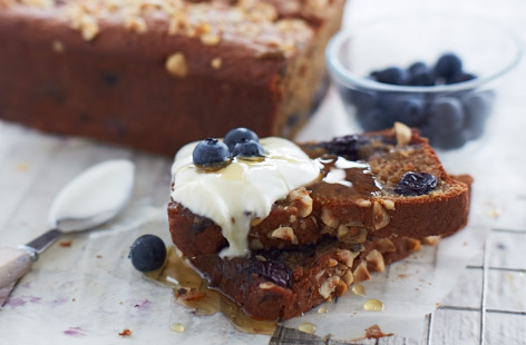 This variation on classic banana bread includes blueberries and yoghurt in the batter and a crunchy hazelnut topping