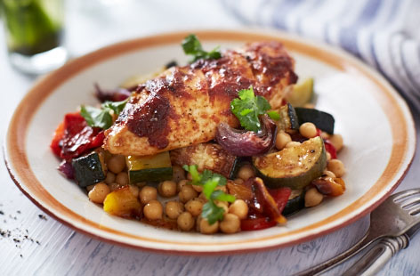 A delicious recipe that makes the most of summer veg. The marinade of garlic, cumin, coriander, harissa and lemon really enhances the chicken, while red onion, peppers and courgettes are gorgeous when fried with crushed chillies and chickpeas.