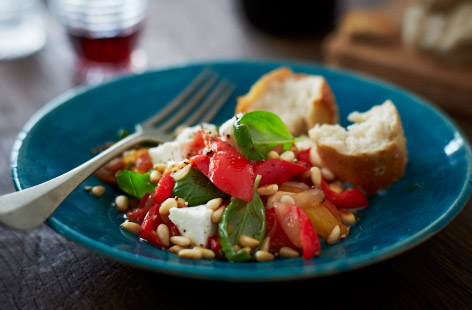 This slow-cooked Italian dish is a great option for those summer days when you're dreaming of holidays. Sweet peppers and tomatoes, and tangy capers, blend beautifully with the potatoes. Feta adds richness and pine nuts add crunch.