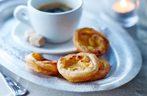 Transport yourself to sunny Lisbon in one bite with these delicious Portuguese custard tarts. Filled with creamy custardy goodness and encased in a flaky, crumbly crust, once you make your own you won't look back. Great as a dessert, or as an afternoon treat.