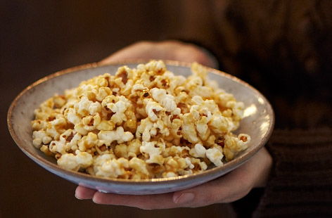 Making sticky toffee popcorn at home is easier than you think. Pop the popcorn as normal in a pan, and make a toffee sauce by melting butter, brown sugar and golden syrup together. Pour over the popcorn then voila, home movie nights just got that little bit more authentic.