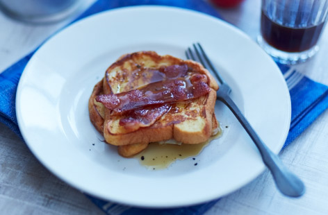 Americans sure know how to make a good breakfast and this recipe for French toast is a real treat. Brioche loaf slices are dunked in an egg, maple syrup and milk mixture before being fried until golden and topped with crisp streaky bacon.