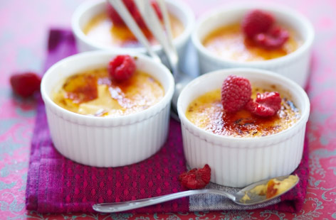 These vanilla and raspberry creme brulées are as pretty as they are delicious. A perfect dinner party dessert for summer, when berries are at their peak. If you don't own a kitchen blow torch, caramelise the tops under a hot grill.