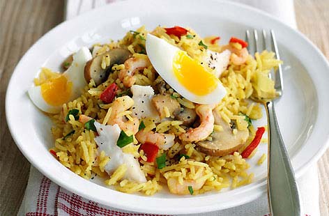 Kedgeree mixes rice, flaked fish, and hard-boiled eggs with curry powder – and this traditional Anglo-Indian fish recipe has been given an update with the addition of red peppers and mushrooms. Here, juicy prawns are added, too.