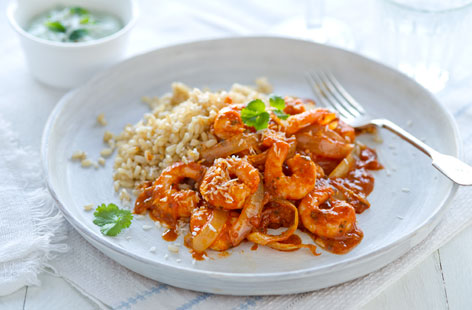 Make a healthier tikka masala with this aromatic curry that lets succulent prawns take centre stage. A hint of fresh ginger brings some heat and desiccated coconut gives it a sweet kick. Make raita with crème fraîche, mint and garlic and enjoy on the side.