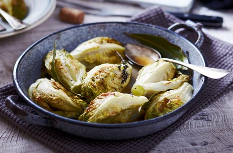 Lettuce doesn't always have enjoyed fresh, surprise your tastebuds with this gently braised little gem. Simply bake in the oven with herbs and stock and serve with roast chicken for a side dish with a difference.