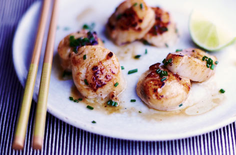 Sweet, juicy scallops need very little attention as they are so delicious. Here they are dressed in lime, lemon juice, and soy sauce after being pan-fried in a grapeseed oil and melted butter. Heavenly. Garnish with just a few snips of chive.