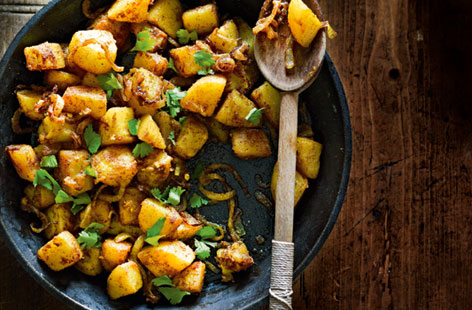 A gorgeous side dish to other Middle Eastern or lightly spiced meals. Ground coriander, cumin, turmeric and cayenne pepper give the chopped potatoes a lovely kick when fried together. Serve with a bit of yogurt on the side.