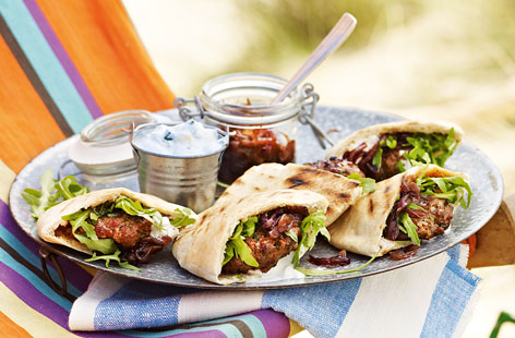 These delicious lamb patties really benefit from being marinated so that the strong flavours of harissa, ginger, onion and garlic meld together. The sticky onions are a sweet, gorgeous addition. Serve the lamb pittas with tzatziki and rocket.