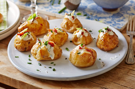These mini stuffed potatoes are incredibly delicious, not to mention cute - they are simply baked, packed with a sour cream, spring onion and chive filling and topped with crispy bacon pieces