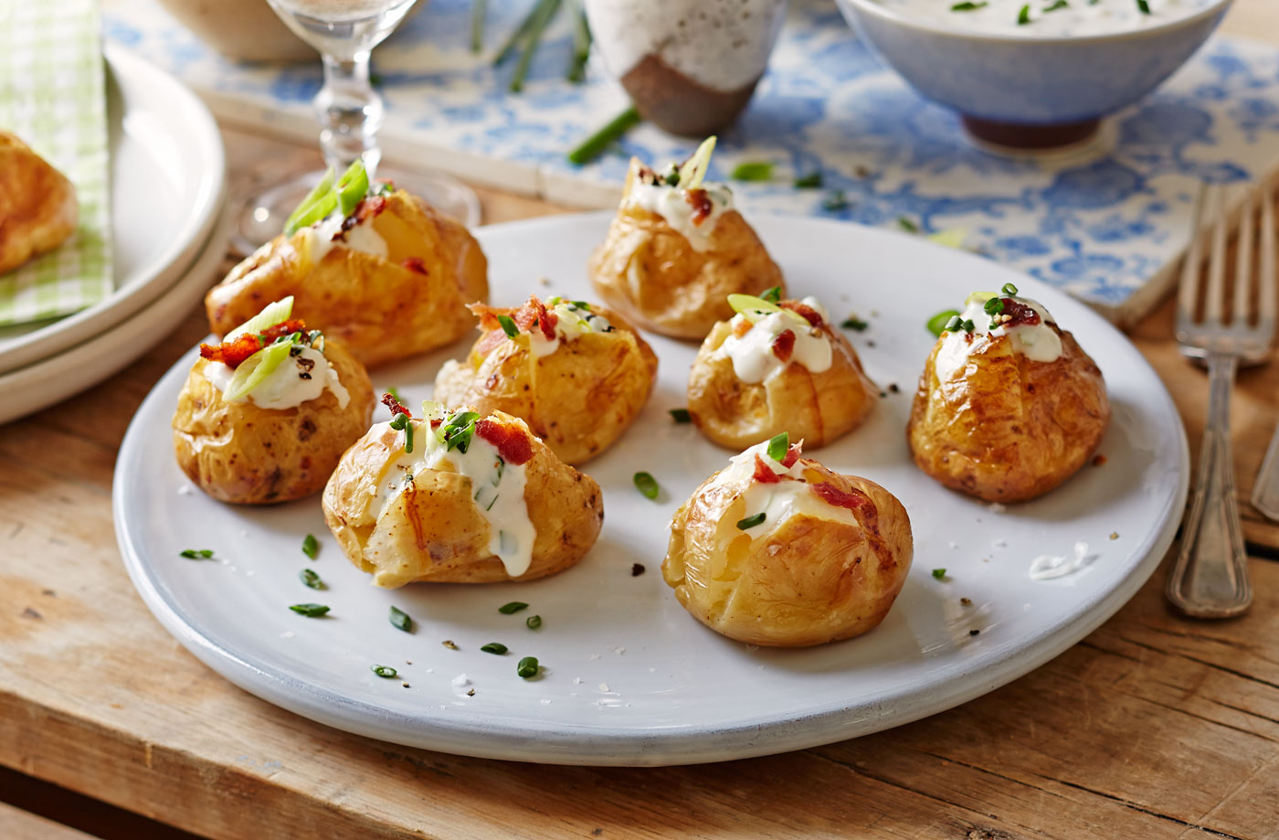 Baked new potatoes with spring onion, sour cream and crispy bacon recipe