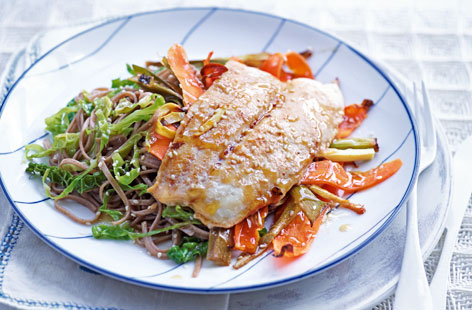 Fuel the family with this nourishing yet quick and simple to create Japanese fish dish with flavour-packed noodles and shredded greens.