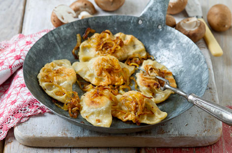 Pierogi are often savoury dumplings, popular in Eastern and Central Europe. The wrappers are made with boiling water, egg and flour, and the filling from cooked button mushrooms, delicious sauerkraut and onions. Simmer them to cook through, then finish in a frying pan to give them a golden crisp sheen.