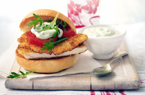 Arm yourself with chicken breasts and just a few extra ingredients and you'll have a burger night on your hands. Here succulent grilled chicken coated with breadcrumbs and parmesan is stuffed into warm bread rolls with herby mayonnaise, tomato and rocket.