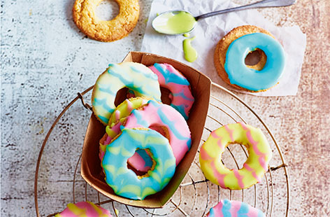 The classic party ring biscuit has been given a totally tropical twist with added desiccated coconut – an easy baking recipe for a delicious sweet treat. Pretty pastel icing tops these cute biscuits
