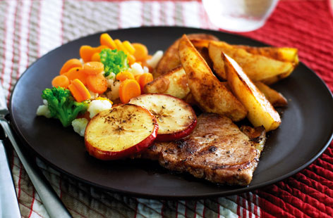Tender pork chops and apples served with spicy potato wedges for a nutritious midweek meal everyone will love.