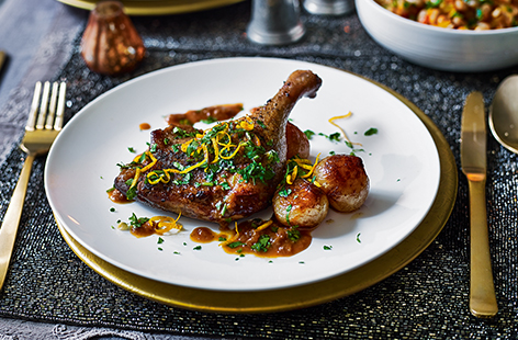 Braised in red wine and zesty orange, these tender duck legs make an indulgent main course paired with sticky-sweet balsamic shallots. Serve as a special dinner for two or as part of a New Year's Eve menu. 