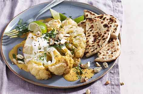 Transform cauliflower by roasting it whole for a striking vegetarian (and vegan) main course or side dish. Rubbed with spices and roasted until crisp, the cauliflower is served with a creamy korma dipping sauce