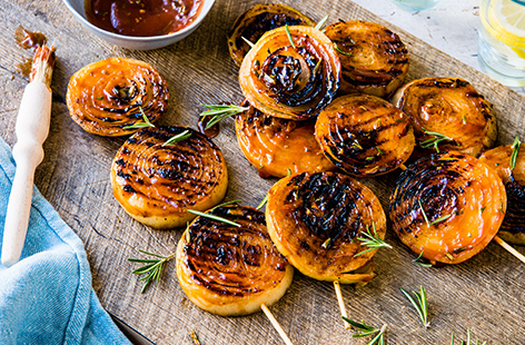 Try a new veggie main on your summer BBQ. These thick onion steaks are skewered and coated in a honey mustard glaze that turns wonderfully sticky and sweet when grilled. Enjoy with coleslaw and potato salad, or serve up alongside burgers and hot dogs.