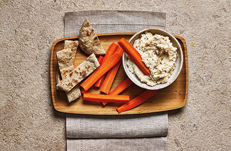 Upgrade your snack game with this creamy garlic and butter bean dip that's made extra creamy with Greek-style yogurt.