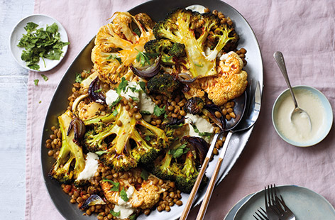 Need some healthy eating inspiration? These roasted broccoli and cauliflower steaks, with caramelised red onions and spicy harissa lentils, make a wonderfully hearty vegan dinner. Finish with fresh coriander and a generous drizzle of creamy houmous sauce.