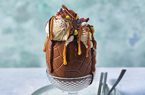 There's no better way to celebrate Easter than with this stunning Easter sundae, loaded with vanilla ice cream and dripping with Belgian chocolate and salted caramel sauce