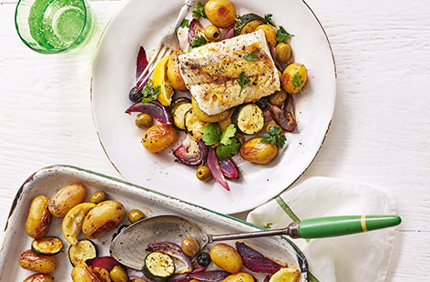 This colourful cod recipe, with fresh citrus flavours and plenty of caramelised roasted veg, makes a delicious stress-free meal for two. Crispy roast potatoes, soft courgettes and tangy olives are the perfect base for the flaky cod.