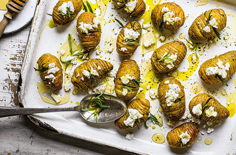 Load hasselback potatoes with fragrant rosemary, tangy goat's cheese and sweet honey for an indulgent side that will really impress
