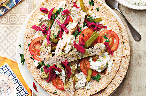 Served with tomatoes, onions and crunchy cornichons, these homemade wraps combine spiced pork and turkey mince for a lighter spin on a takeaway classic.