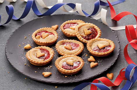 Dainty jam tarts are a classic afternoon tea treat. This easy recipe gives the traditional British jam tart an American twist with a dollop of creamy peanut butter alongside the sweet strawberry jam.