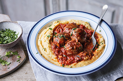 Creamy blue cheese polenta is the perfect winter comfort food. Serve as a hearty alternative to mash or spaghetti with these juicy beef meatballs and a herby tomato sauce.