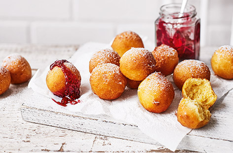 You can be enjoying hot, fluffy mini doughnuts in just 15 minutes with this clever recipe. These moreish ricotta treats are crispy on the outside and deliciously soft on the inside, perfect for dipping into warm raspberry jam. 
